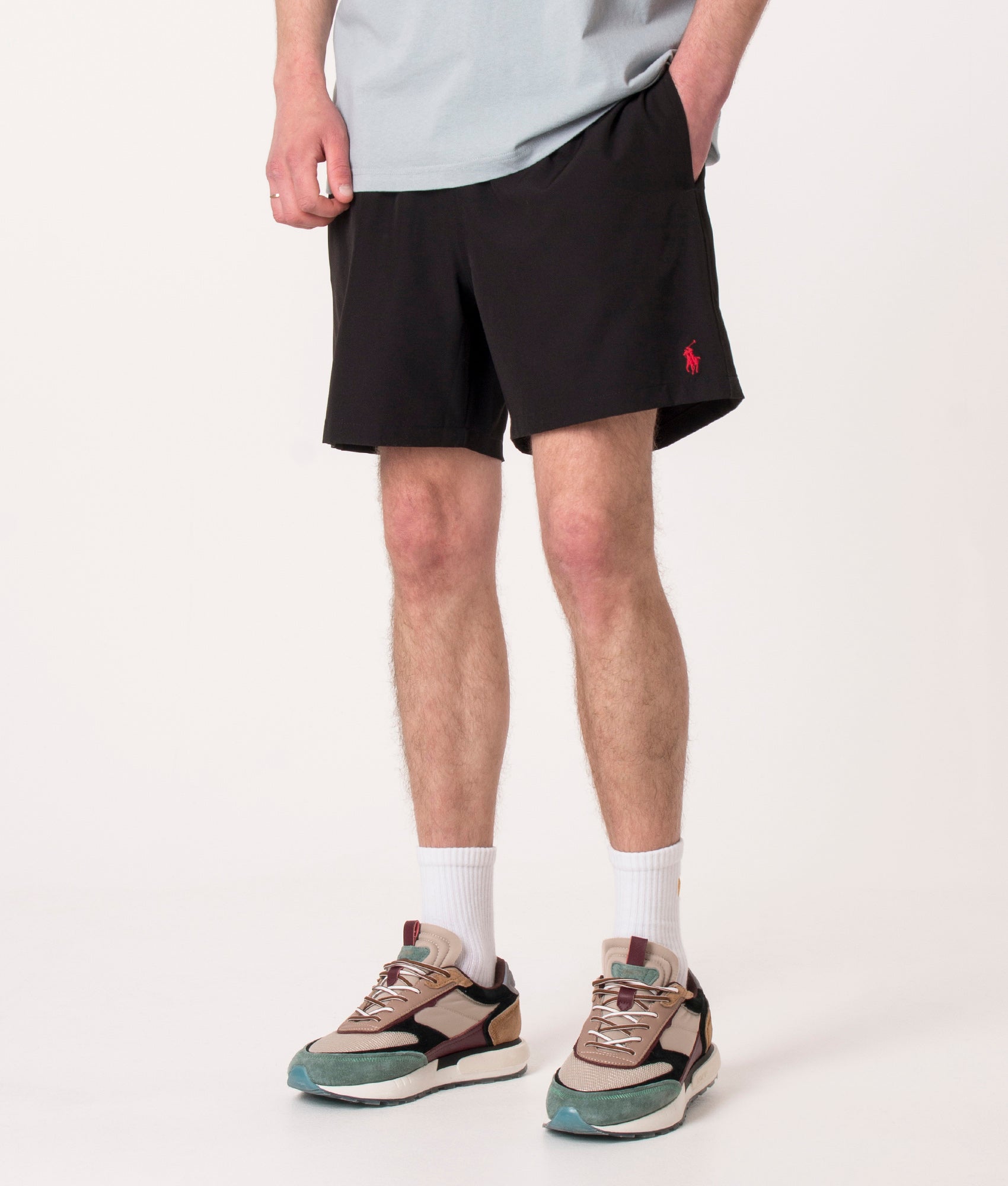 Polo Ralph Lauren Regular Fit Traveler Mid Swim Shorts in Polo Black at EQVVS Menswear. Angled model front shot.