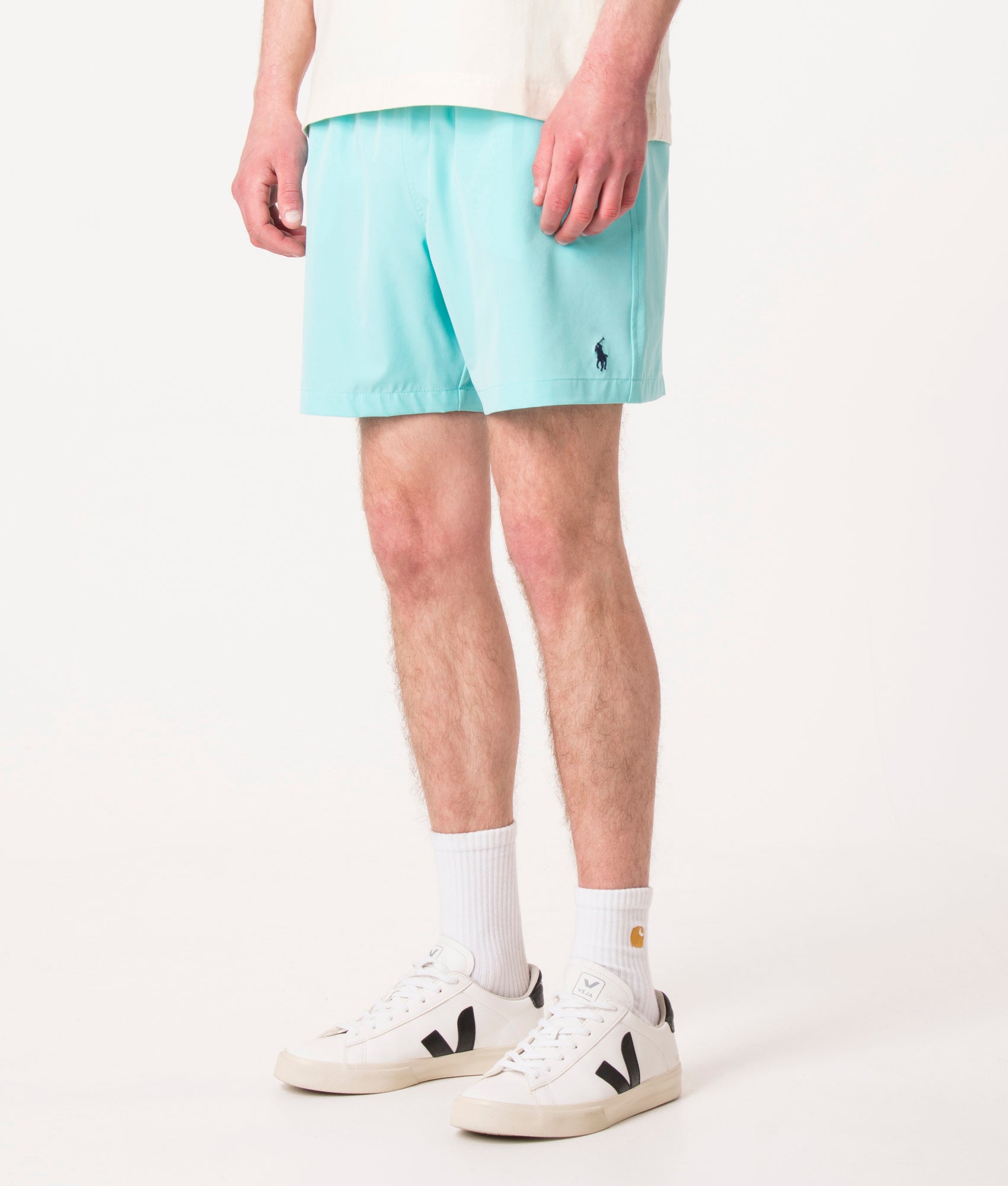 Polo Ralph Lauren Regular Fit Traveler Mid Swim Shorts in Hammond Blue at EQVVS Menswear. Angled model front shot.