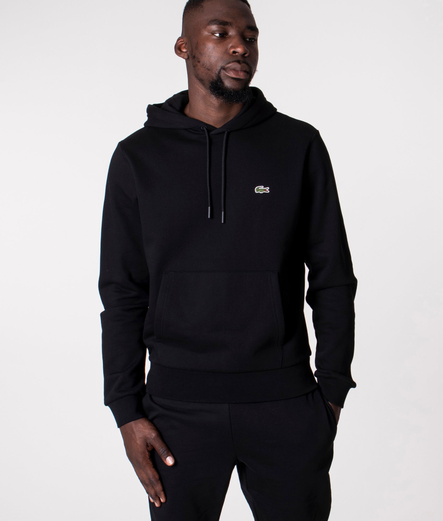 Lacoste Relaxed Fit Brushed Fleece Hoodie in Black at EQVVS Menswear. Model front shot.
