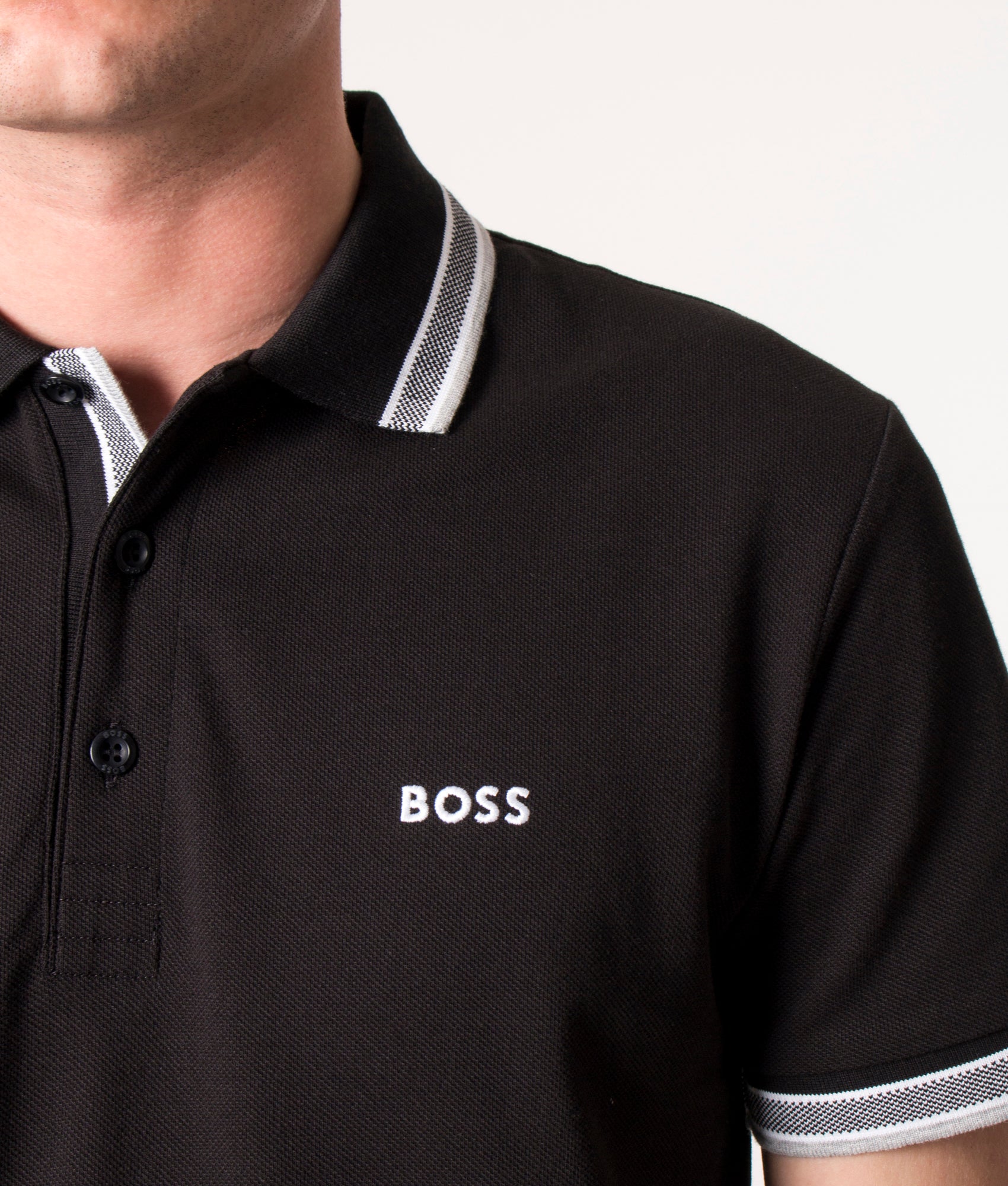BOSS Paddy Polo Shirt in Black at EQVVS Menswear. Detail shot.
