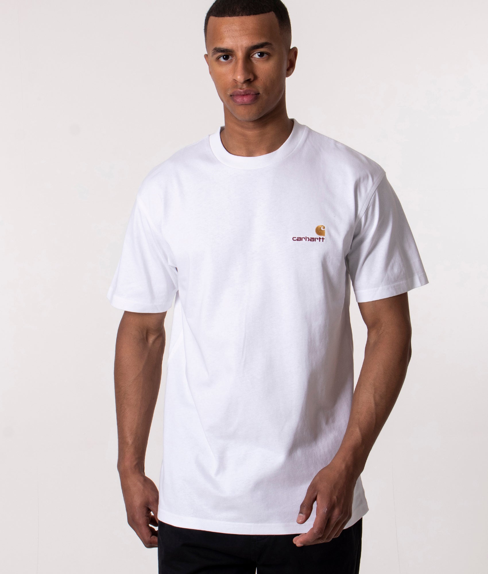 Carhartt WIP Loose Fit American Script T-Shirt in White at EQVVS Menswear. Model shot.