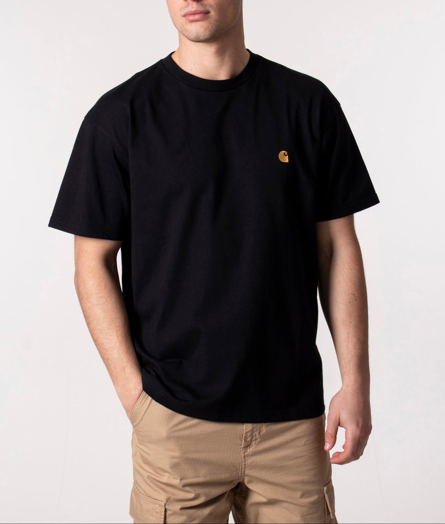 Carhartt WIP Loose Fit Chase T-Shirt in Black and Gold at EQVVS Menswear. Model front shot.