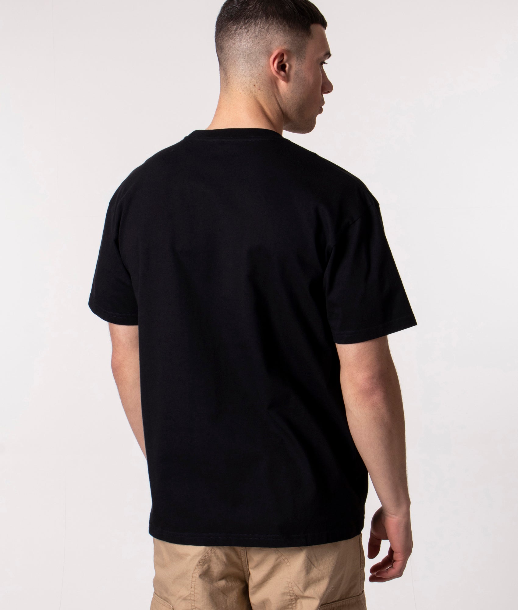 Carhartt WIP Loose Fit Chase T-Shirt in Black and Gold at EQVVS Menswear. Model back shot.