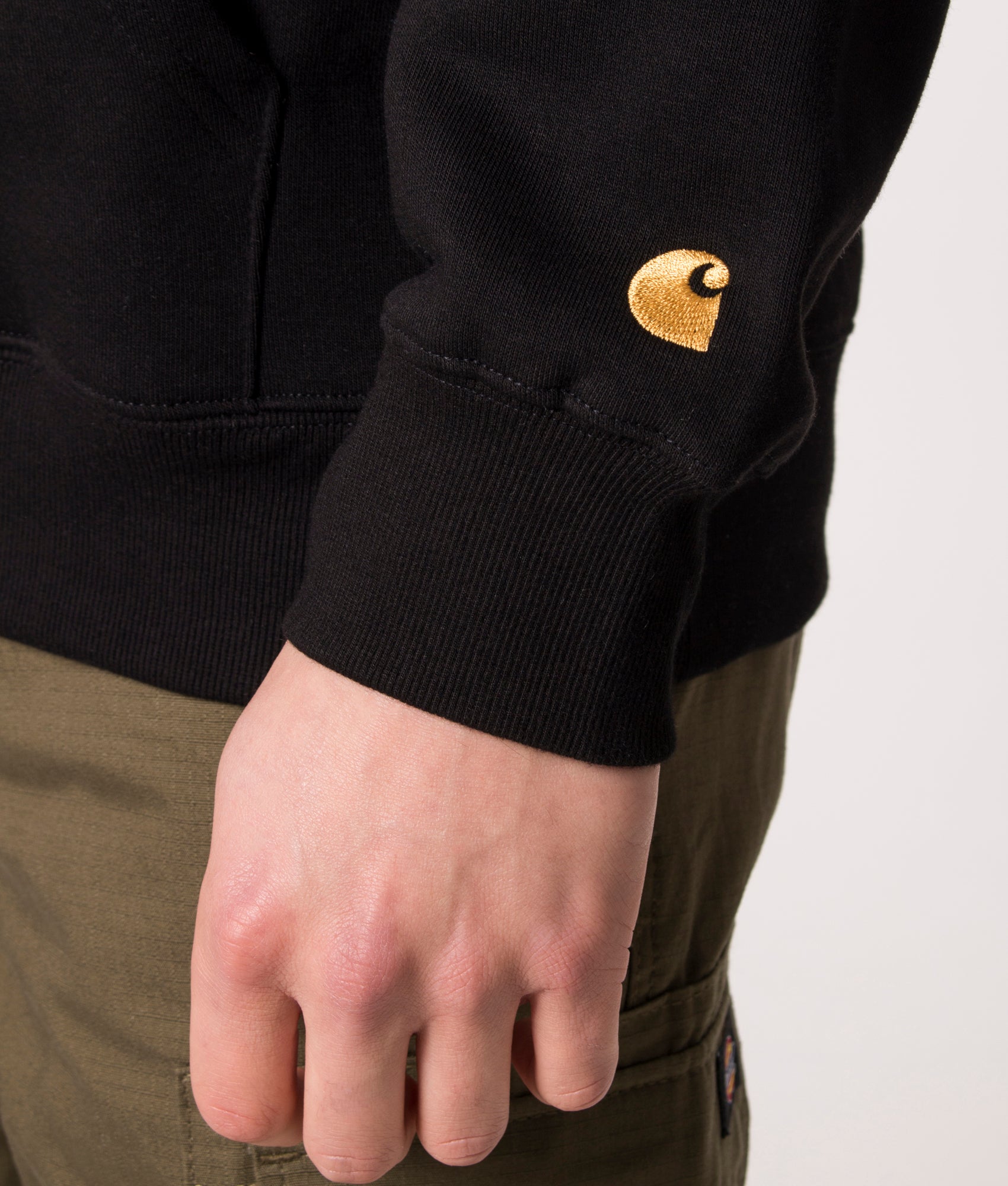 Carhartt WIP Quarter Zip Chase Sweatshirt in Black and Gold at EQVVS Menswear. Detail shot.