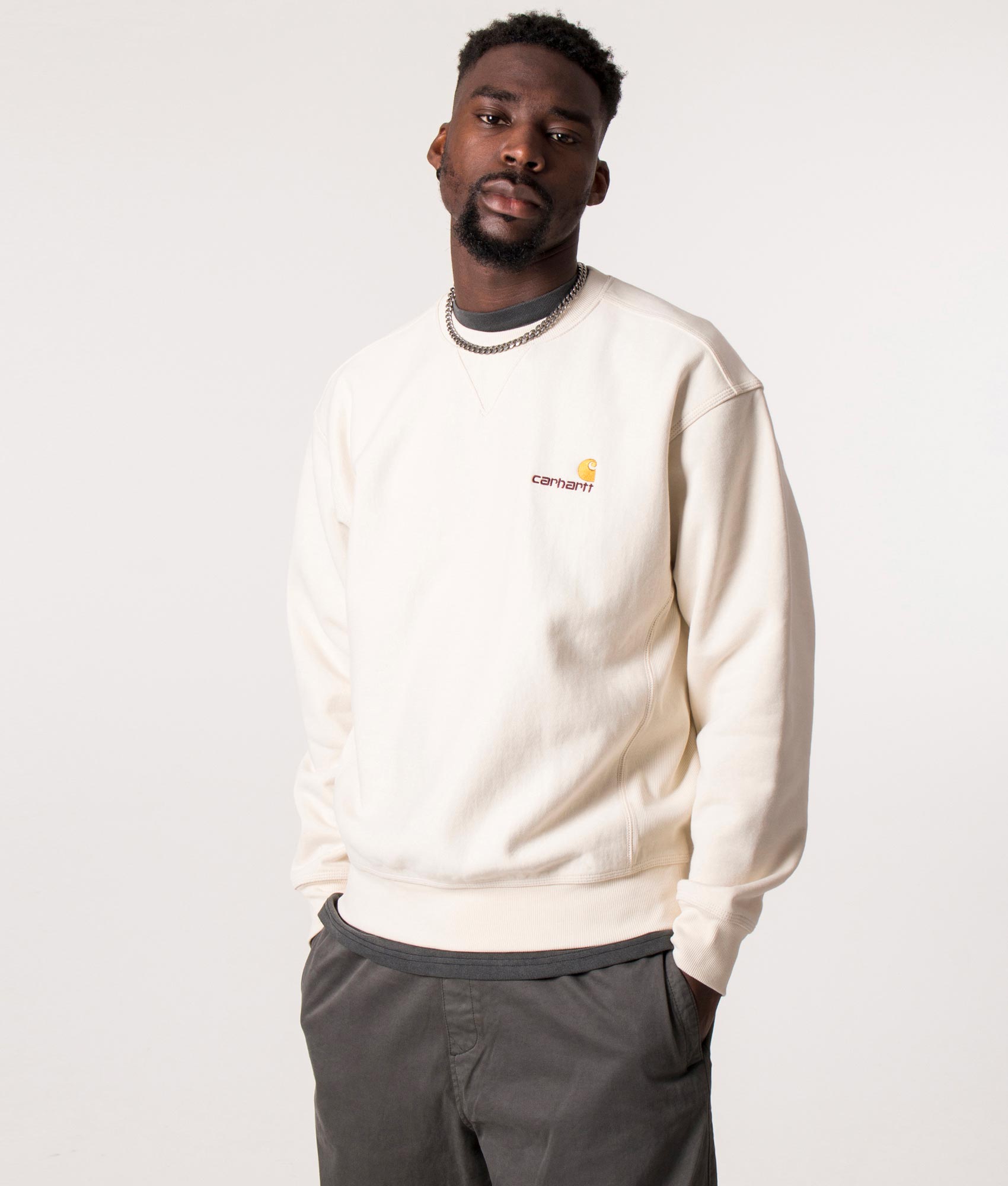 Carhartt WIP staple, the Relaxed Fit American Script Sweatshirt in Natural at EQVVS Menswear. Model shot.