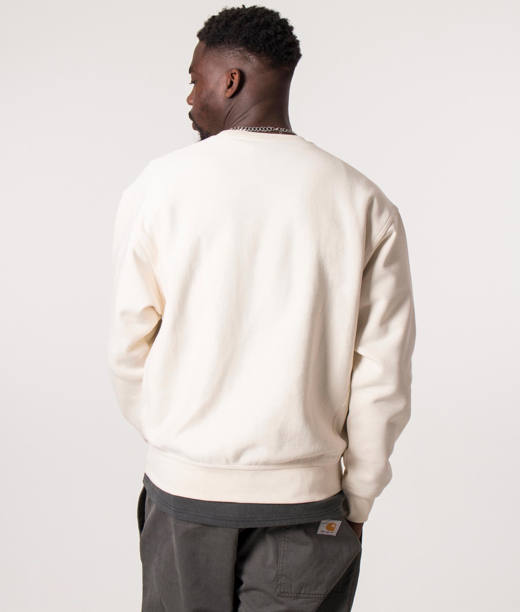 Carhartt WIP staple, the Relaxed Fit American Script Sweatshirt in Natural at EQVVS Menswear. Model back shot.