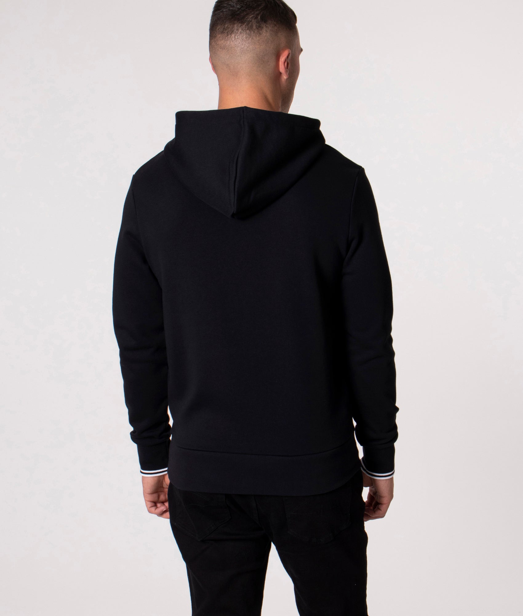 Fred Perry Twin Tipped Hoodie in Black at EQVVS Menswear. Model back shot.
