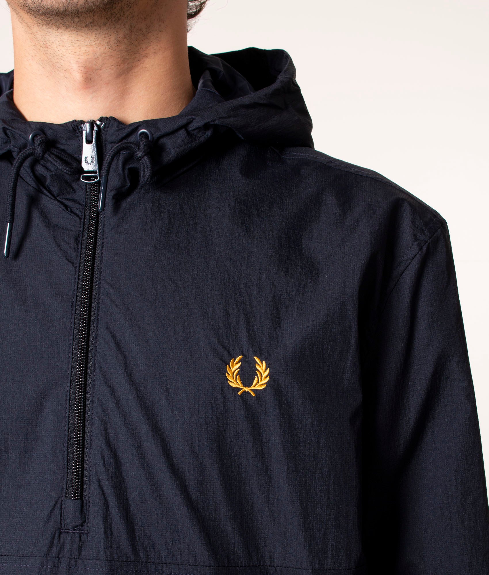 Fred Perry Half Zip Hooded Cagoule in Navy at EQVVS. Model, Detail.