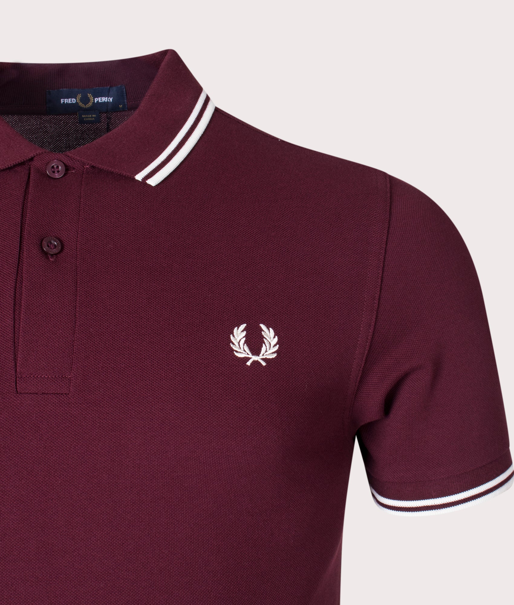Fred Perry Twin Tipped Polo Shirt in Oxblood at EQVVS Menswear. Detail shot.