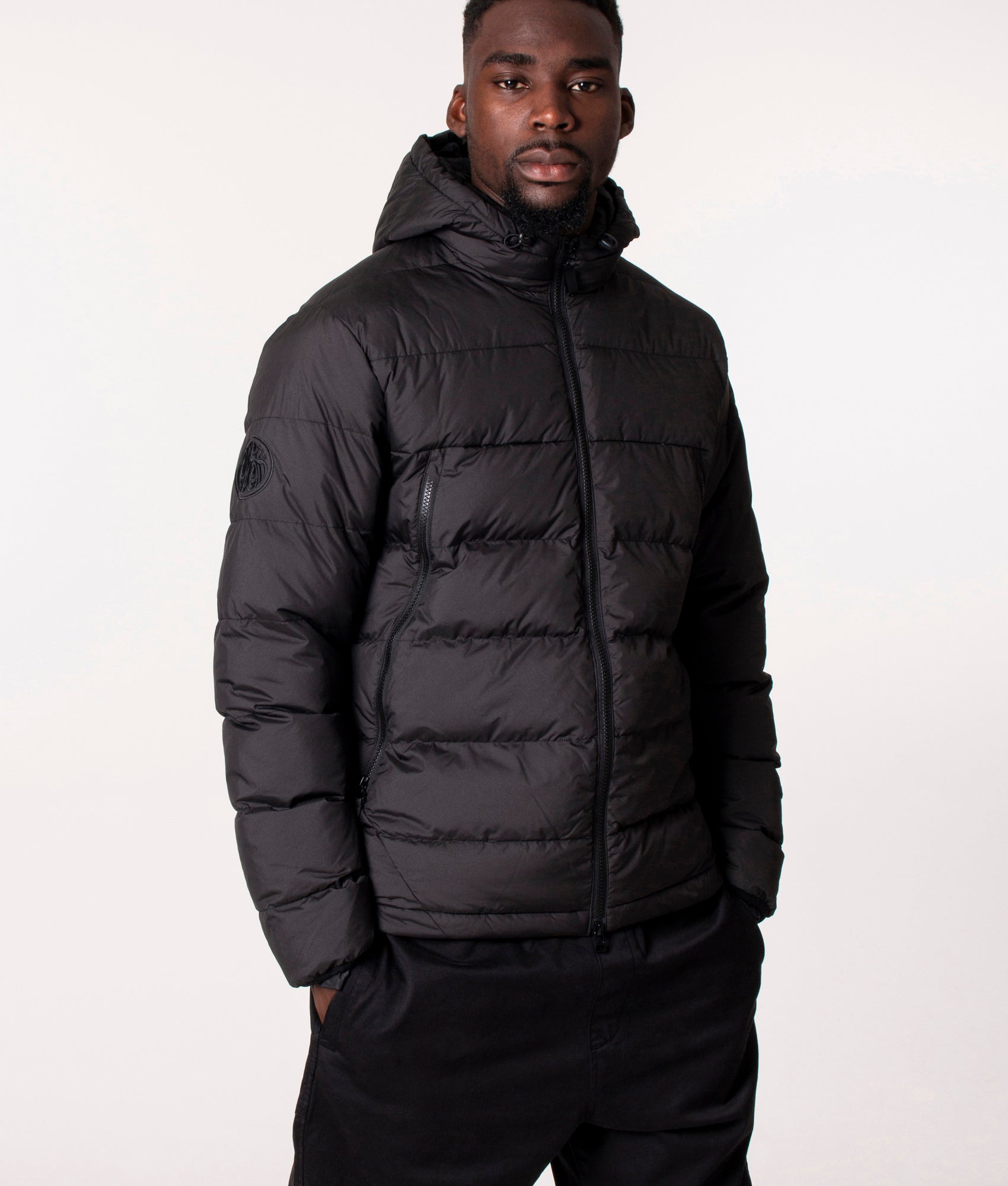 Pretty Green Cyclone Quilted Jacket in Black at EQVVS, Model front angle